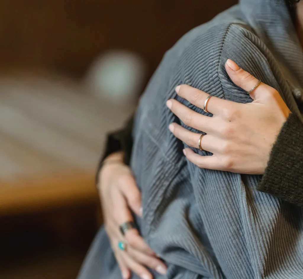 Supportive embrace between two people during trauma recovery counseling