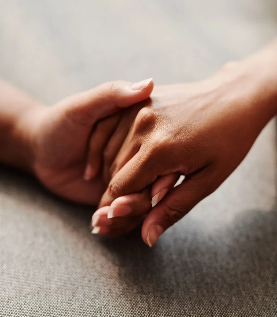 Two people holding hands, representing secure attachment and relational healing