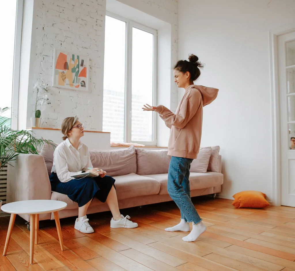 Client and counselor talking in a bright, relaxed room about a life transition
