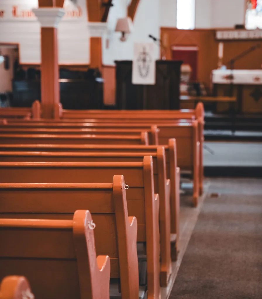 Quiet church sanctuary with empty wooden pews